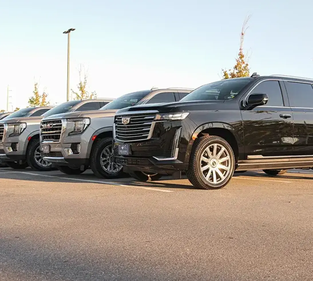 Parents leading kids into the private car service