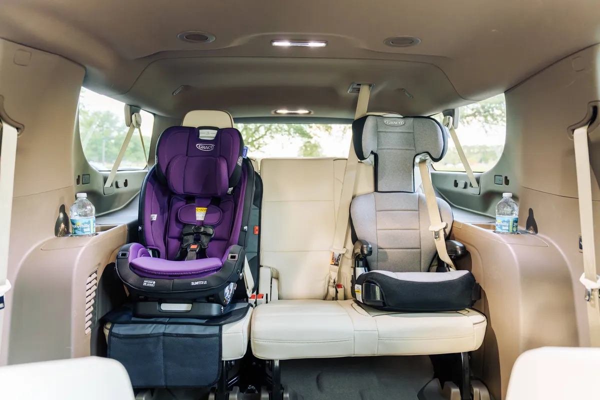 Clean, complimentary child safety car seats installed in a premium vehicle for secure family private transportation by The Genie.