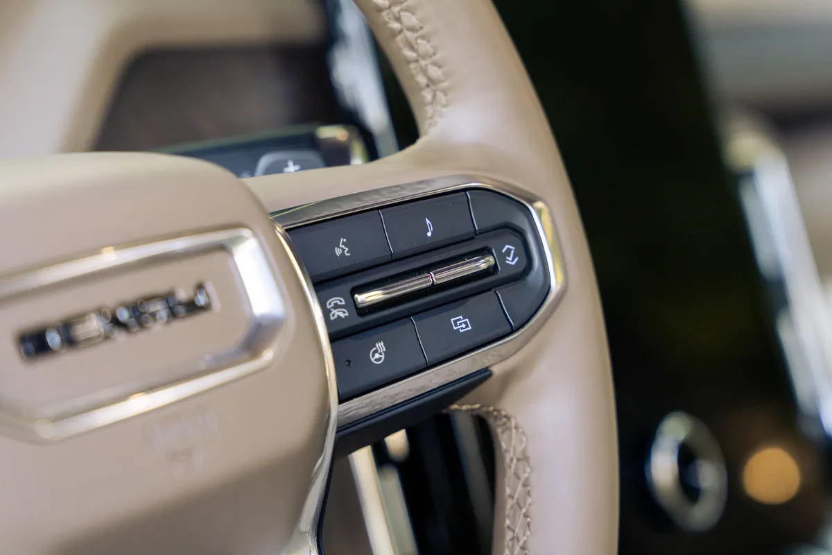 Close-up of the steering wheel and clean, premium interior of a luxury private transportation vehicle by The Genie Orlando.