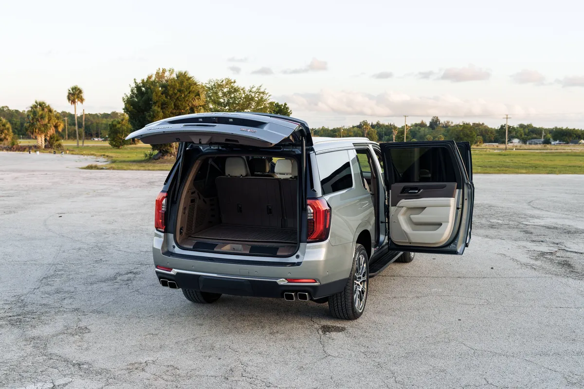 Rear view of a luxury private vehicle showing a spacious interior and large trunk capacity for seamless Orlando airport travel by The Genie.