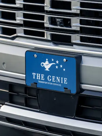 Close up of The Genie plate of a premium private transportation vehicle