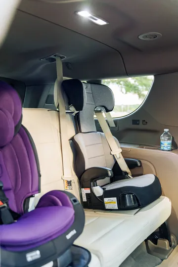 Clean, complimentary child safety car seat installed in a premium vehicle for secure private family transportation by The Genie.