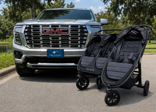 Baby Jogger single and double strollers with luxury private transport vehicles in the background for Disney World stroller rentals by The Genie.